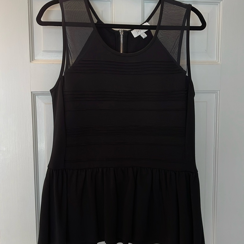 NWOT Jaye.e black peplum top. Net and silver zipper at back.